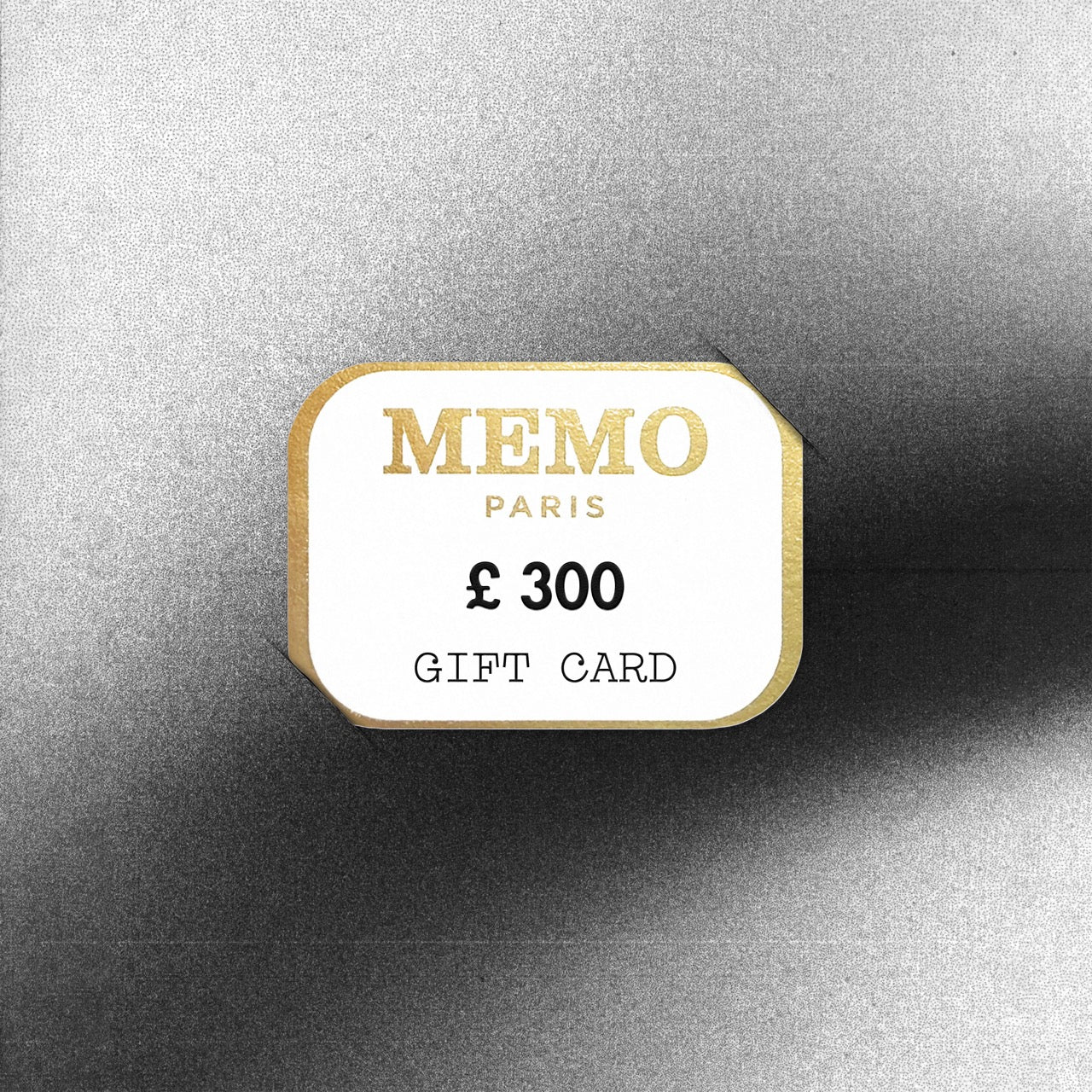 A white and gold memo paris gift card with elegant typography and a 300 pound value celebrating dream destinations