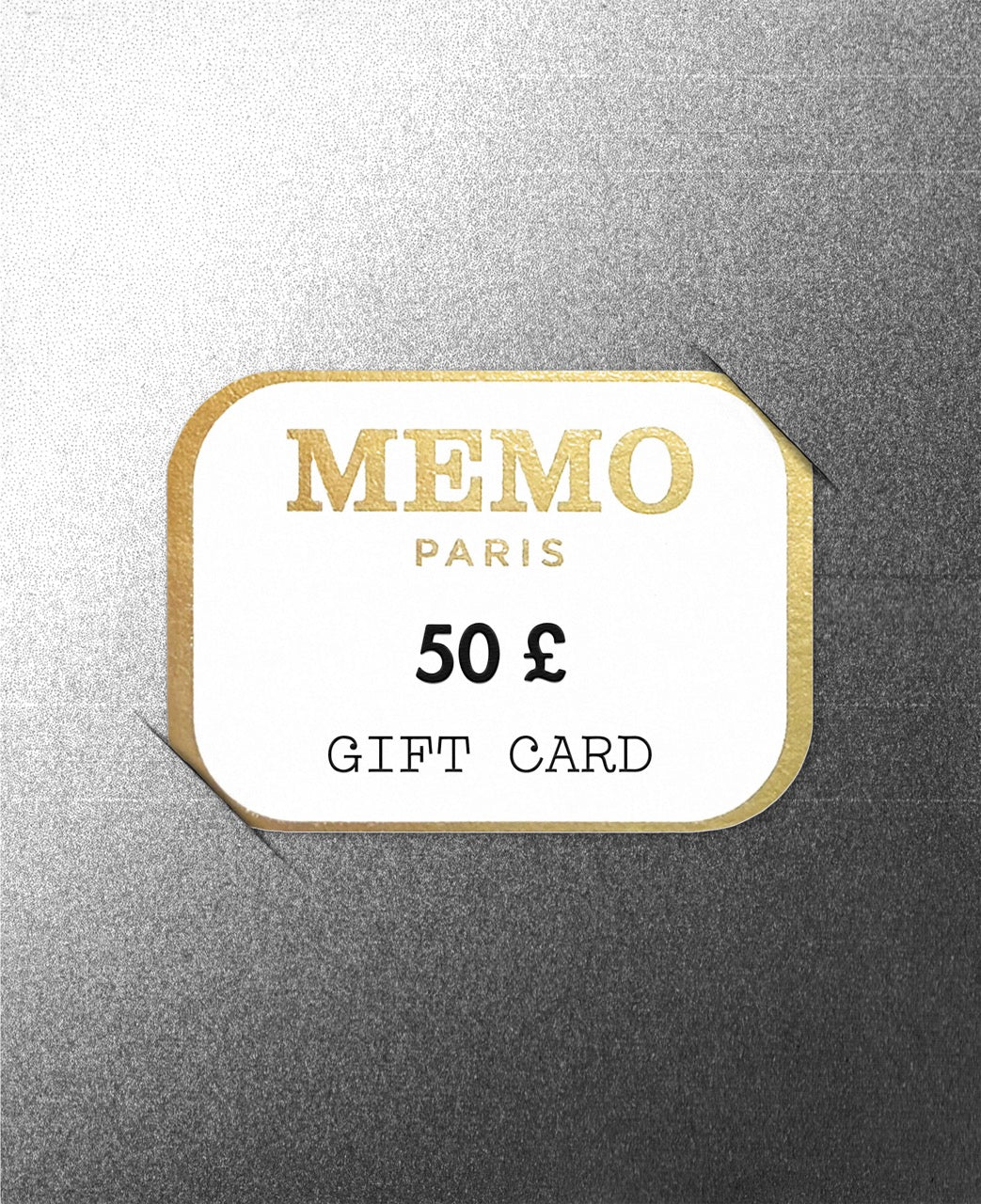 A white rectangular memo paris gift card with gold foil lettering and border valued at 50 £ for celebrating dream destinations