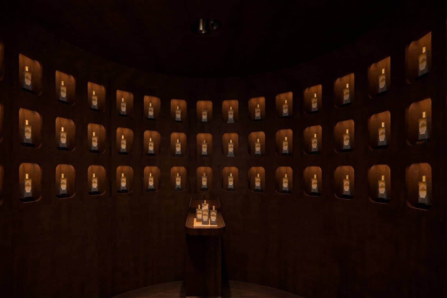 Rows of identical amber glass bottles, each with a white label and gold foil cap, are displayed in recessed wooden niches within a dimly lit circular room.