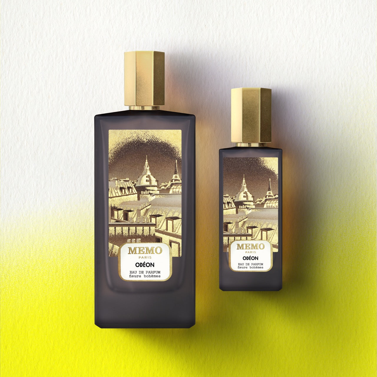 Two dark glass perfume bottles with gold caps from memo paris signature duet odéon featuring tonka bean scent