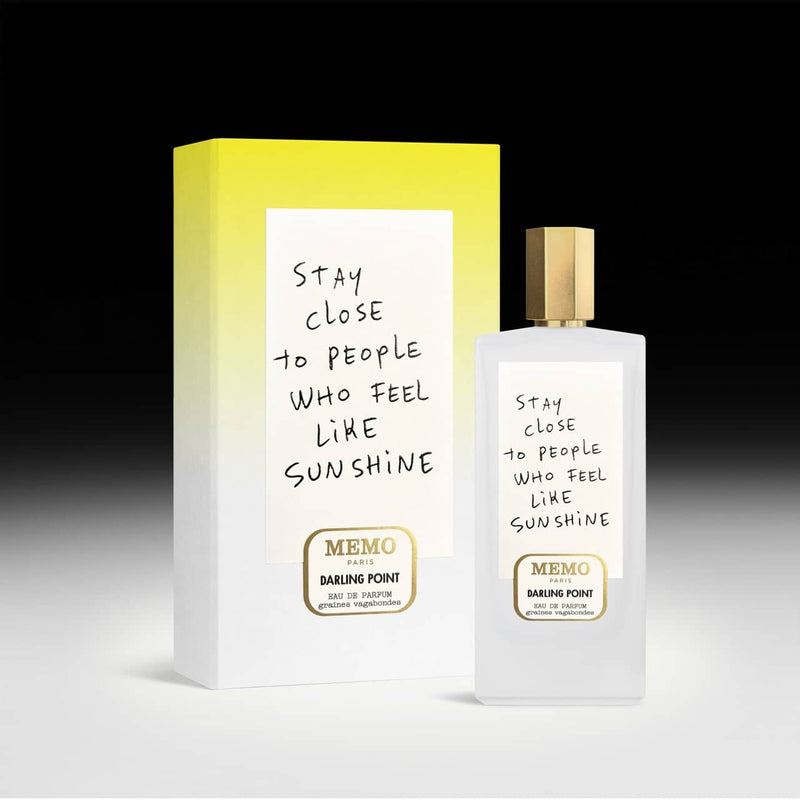 White frosted glass perfume bottle with a gold cap and handwritten-style label reading ’stay close to people who feel like sunshine,’ from memo paris’ darling point fragrance.